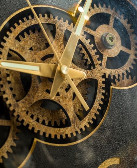 black and gold moving gears clock